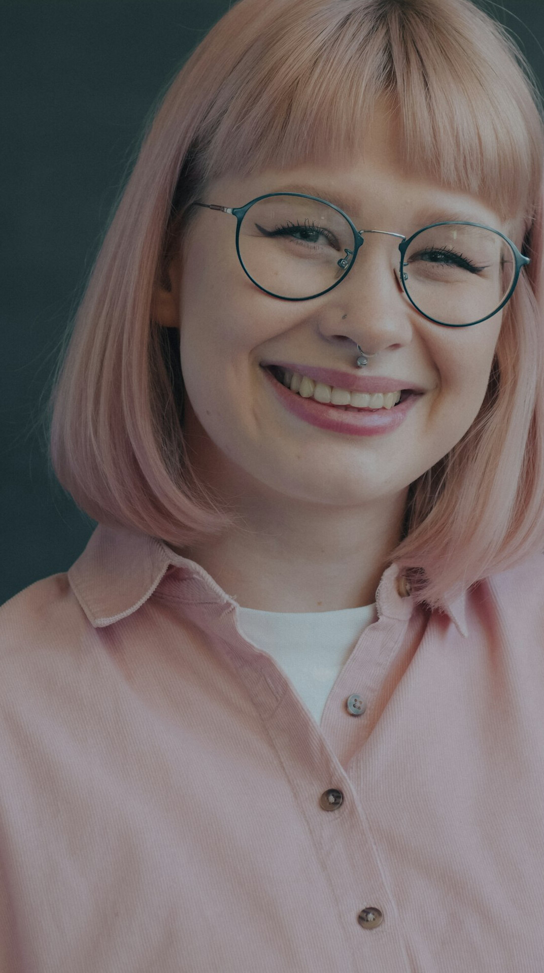 Studio portrait of an Asian woman analyst smiling