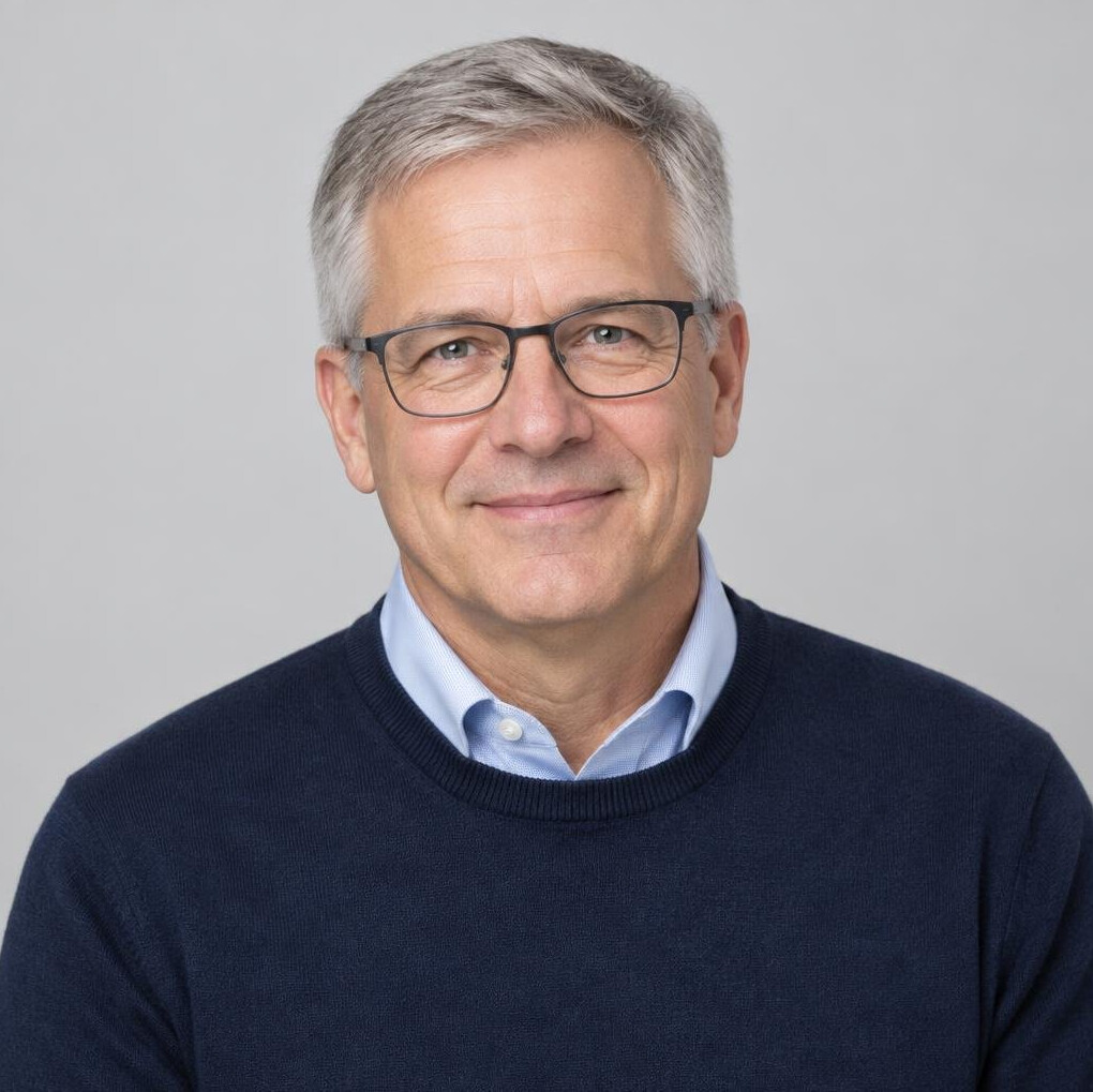 Studio portrait of an older man trainer with glasses